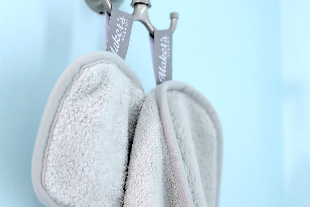 two makeup remover cloths hanging to dry